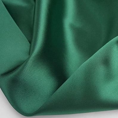 A close-up of Longan Craft's Multicolor Satin Fabric By The Yard shows shiny, silky polyester satin cloth gently folded, highlighting its glossy texture—perfect for apparel and crafts.