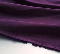 A close-up of Longan Craft's Multicolor Satin Fabric by the Yard shows its silky polyester satin texture and unfinished edge, laid out with soft folds on a light surface—ideal for stylish apparel projects.