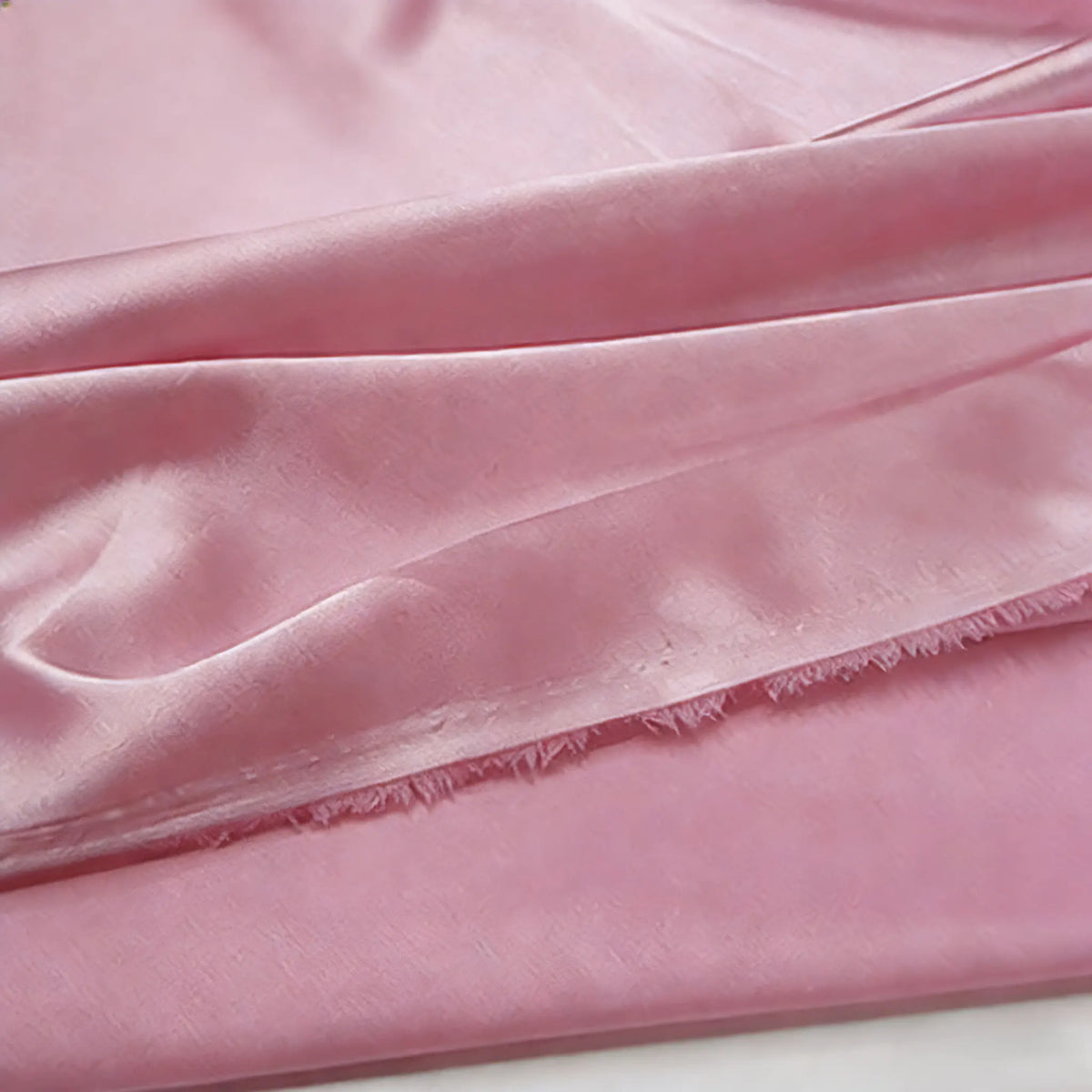 A close-up of Longan Craft Multicolor Satin Fabric By The Yard showcases its silky polyester satin texture with gentle folds and a slightly crinkled finish—perfect for apparel and textile projects.