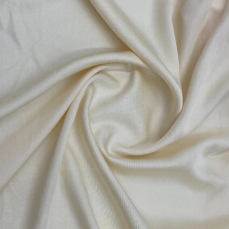 A close-up of Longan Craft's Multicolor Satin Viscose Fabric by the yard, made from 100% viscose cellulose, arranged in soft folds to highlight its silky texture and gentle sheen—ideal for stylish evening gowns.