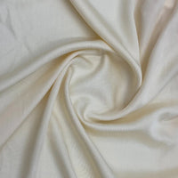 A close-up of Longan Craft's Multicolor Satin Viscose Fabric by the yard, made from 100% viscose cellulose, arranged in soft folds to highlight its silky texture and gentle sheen—ideal for stylish evening gowns.