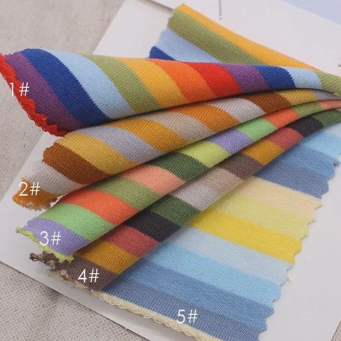 Five swatches of Longan Craft Multicolor Striped Cotton French Terry Fabric By The Yard (#1 to #5) are fanned out on a light surface. This soft, stretch knit is perfect for warm sweatshirt projects.