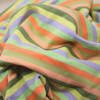 A close-up of Longan Craft Multicolor Striped Cotton French Terry Fabric by the yard, featuring soft, crumpled stretch knit with horizontal pastel orange, green, lavender, and peach stripes—ideal for cozy sweatshirts.