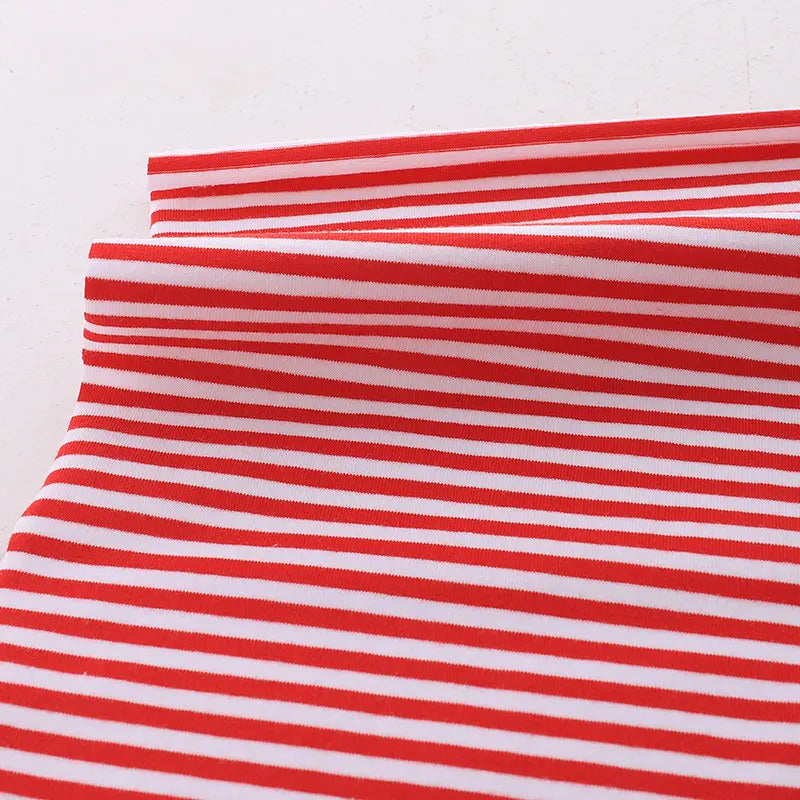 A close-up of Longan Craft Multicolor Striped Cotton Jersey Fabric by the yard, a stretch elastane sports jersey material, neatly folded on a white surface.