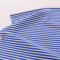 The Longan Craft Multicolor Striped Cotton Jersey Fabric by the yard, a stretch elastane sports jersey material, is displayed on a white surface with gentle folds and visible blue and white stripes.