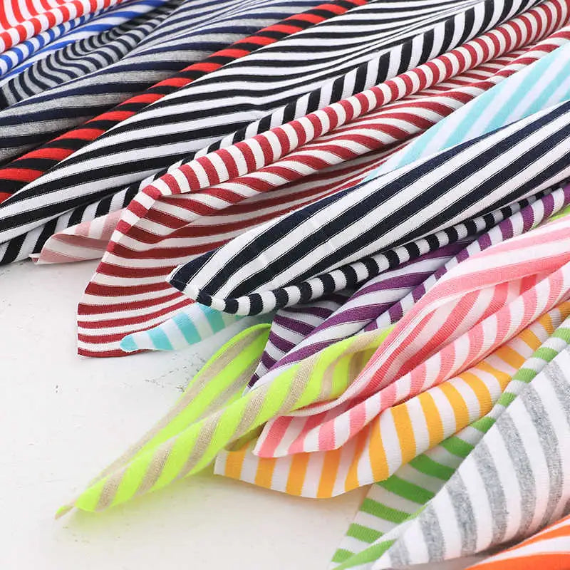 Longan Craft’s Multicolor Striped Cotton Jersey Fabric by the Yard features vivid overlapping stripes in red, black, blue, purple, yellow, pink, green, and gray—perfect stretch elastane jersey for sports or crafts.