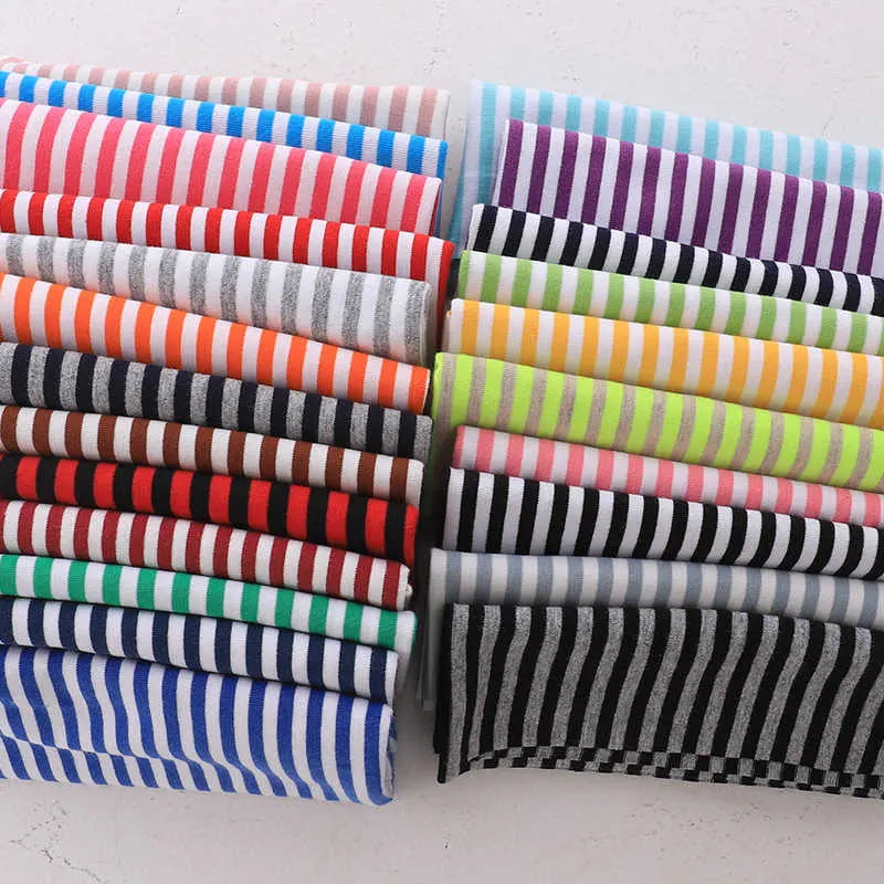 Longan Craft's Multicolor Striped Cotton Jersey Fabric by the yard features neatly stacked pieces with vibrant stripes—red, orange, yellow, green, blue, purple, black, grey, and white—on a light background. Stretch elastane sports jersey material.