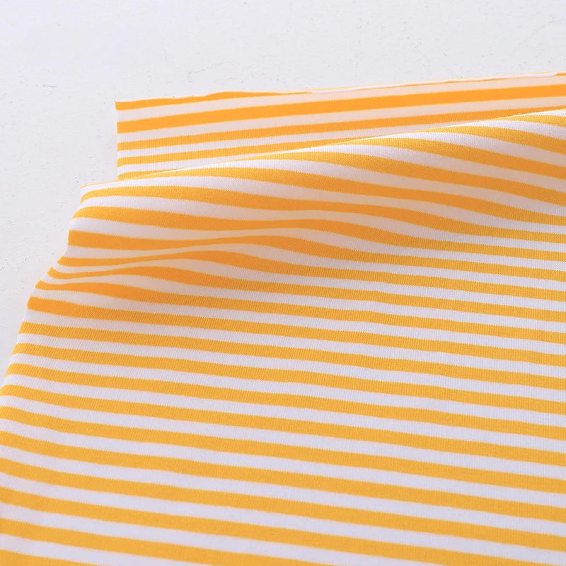 Longan Craft’s Multicolor Striped Cotton Jersey Fabric By The Yard is shown laid flat, with smooth, evenly spaced horizontal yellow and white stripes. This stretch elastane jersey fabric is ideal for sportswear and apparel projects.