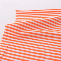 Longan Craft's Multicolor Striped Cotton Jersey Fabric By The Yard is shown draped flat, its stretch elastane jersey material featuring horizontal orange and white stripes with soft folds for a textured sports jersey look.