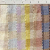 A swatch of Longan Craft’s Multicolor Washed Plaid Linen Fabric By The Yard is shown, featuring vertical stripes in pastel shades and scalloped edges between some of the stripes. The ruler at the top is marked from 2 to 6 cm, highlighting the scale of this vintage checkered pure linen material, perfect for casual wear.