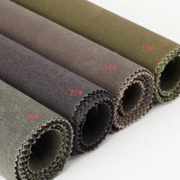 Longan Craft's Multicolor Waxed Cotton Canvas Fabric by the yard, 100% cotton and waterproof, is arranged in a row in muted green, brown, and gray rolls labeled 16#, 17#, 26#, and 27#—perfect for outdoor clothing.