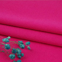 A close-up of bright pink Multiple Colors Linen Fabric By The Yard from Longan Craft, a washed cotton linen blend known for its softness, durability, and breathable natural fibers—shown here with dried blue flowers on top.