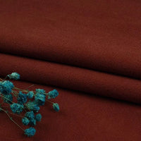 A close-up of Longan Craft’s Multiple Colors Linen Fabric By The Yard, a durable washed cotton linen blend for apparel, in dark reddish-brown with blue dried flowers on top. The natural fiber texture and contrasting colors are visible.