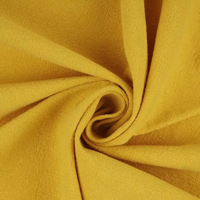 A close-up of yellow Multiple Colors Linen Fabric By The Yard from Longan Craft, a washed cotton linen blend for apparel, twisted into a spiral to display its texture and soft folds.
