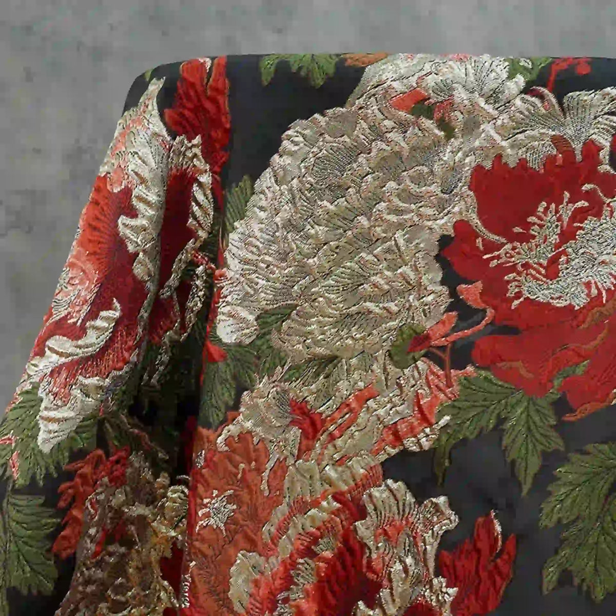 Longan Craft's Peony Embossed Metallic Brocade Fabric features a luxurious golden and black floral jacquard texture with red, cream, and gold peonies on a dark background, perfect for elegant formal dresses.