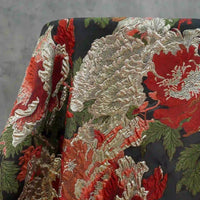 Longan Craft's Peony Embossed Metallic Brocade Fabric features a luxurious golden and black floral jacquard texture with red, cream, and gold peonies on a dark background, perfect for elegant formal dresses.