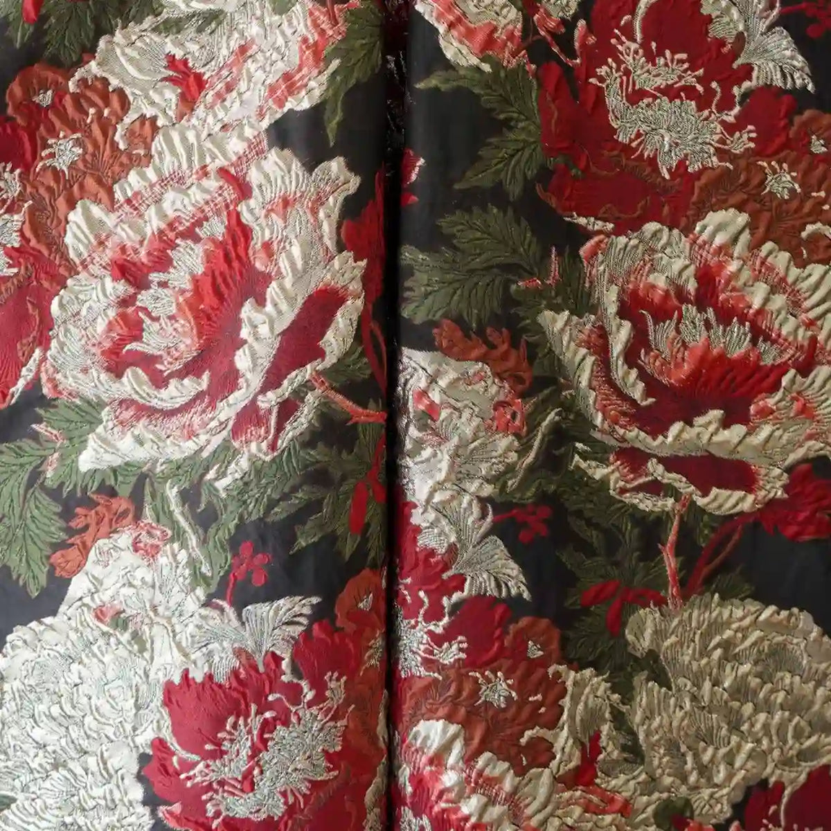 A close-up of Longan Craft’s Peony Embossed Metallic Brocade Fabric by the yard, featuring luxurious golden black floral jacquard texture with ornate peony patterns—ideal for formal dresses.