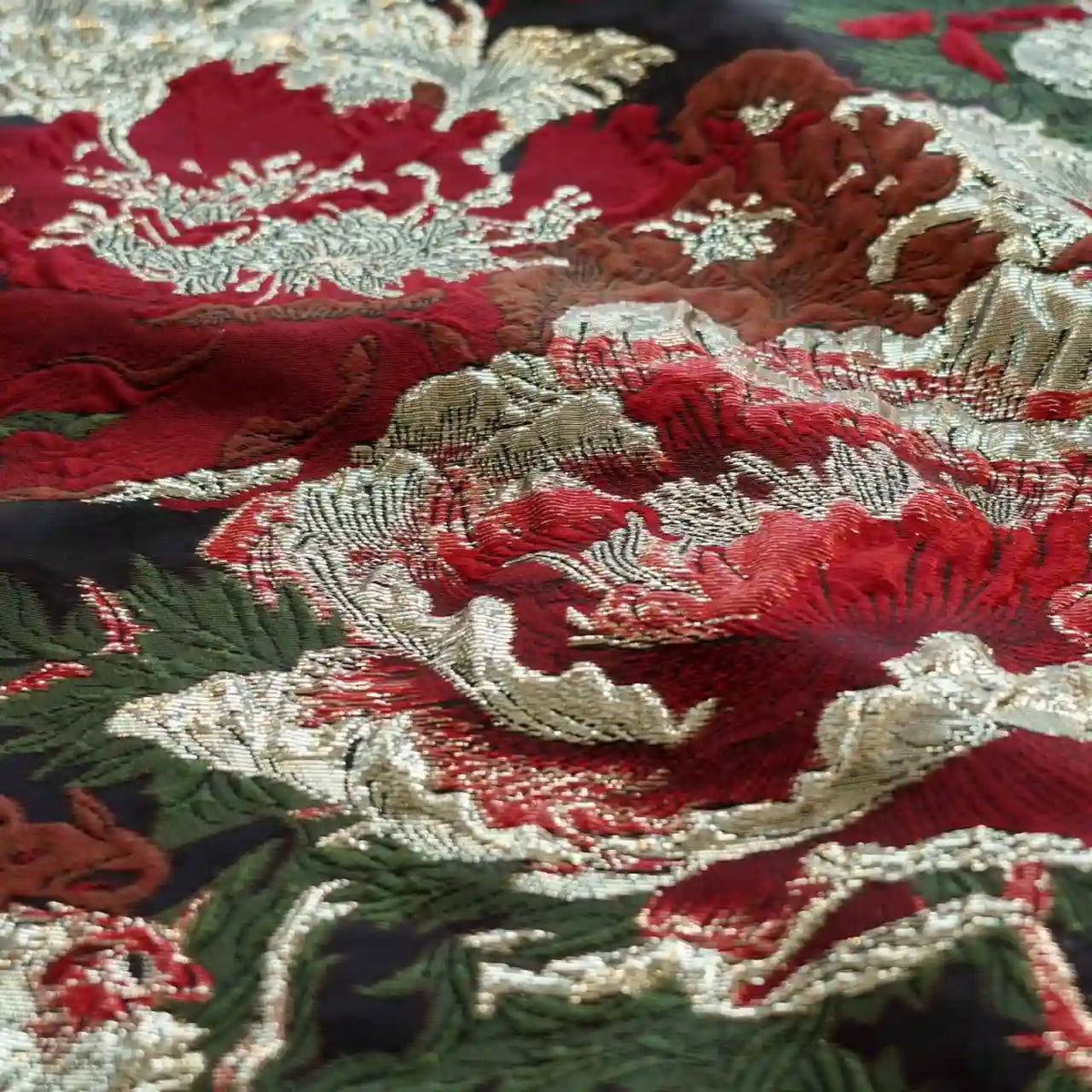 Close-up of Longan Craft’s Peony Embossed Metallic Brocade Fabric: golden black floral jacquard with intricate raised patterns, ideal for formal dresses and luxury projects.
