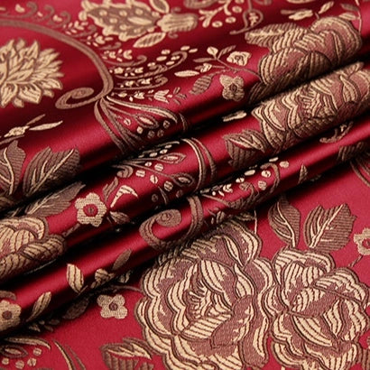 Longan Craft's Peony Jacquard Brocade Fabric By The Yard features colorful Chinese floral patterns with metallic gold accents on deep red, perfect for formal dresses and bridal gowns. Ornate flowers and leaves are woven for a luxurious look.