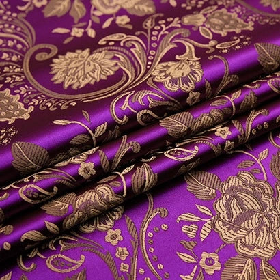 A close-up of folded Peony Jacquard Brocade Fabric By The Yard from Longan Craft, showcasing its colorful Chinese floral brocade and detailed gold roses—ideal material for crafting elegant formal or bridal dresses.