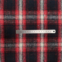 A silver ruler lies across Longan Craft Plaid Brushed Mammoth Flannel Fabric By The Yard, measuring 0–15 cm on colorful polyester cotton flannel with a classic tartan pattern—perfect comfy fall material.