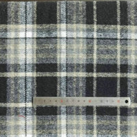 A piece of Longan Craft's Plaid Brushed Mammoth Flannel Fabric By The Yard, featuring black, white, gray, and beige plaid, is shown with a metal ruler across the bottom to display the pattern size.