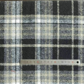 A piece of Longan Craft's Plaid Brushed Mammoth Flannel Fabric By The Yard, featuring black, white, gray, and beige plaid, is shown with a metal ruler across the bottom to display the pattern size.