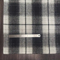 A Plaid Brushed Mammoth Flannel Fabric by Longan Craft is laid flat, with a metal ruler measuring about 15 cm placed horizontally across the colorful polyester cotton flannel near the left side.