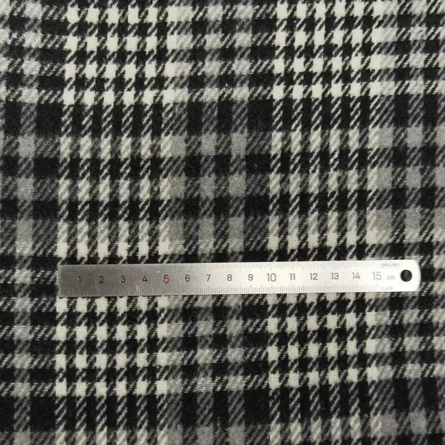 A metal ruler measuring 1–15 cm is placed on Longan Craft's Plaid Brushed Mammoth Flannel Fabric By The Yard, a comfy, colorful polyester cotton flannel—ideal material for fall projects.