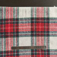 The Longan Craft Plaid Brushed Mammoth Flannel Fabric By The Yard, a colorful polyester cotton fall flannel, is shown on a flat surface with a metal centimeter ruler at the bottom for size reference.