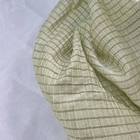 A close-up of Longan Craft’s Plaid Jacquard Lyocell Fabric by the Yard, a multicolor checked, breathable lyocell textile for apparel, draped over a white background to highlight its unique texture and semi-transparency.