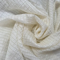 Longan Craft’s Plaid Jacquard Lyocell Fabric By The Yard features a multicolor checked design on breathable, sustainable lyocell, softly draped to highlight its gentle folds and light shadow—ideal for apparel and creative projects.