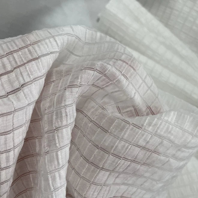 Close-up of Longan Craft’s Plaid Jacquard Lyocell Fabric By The Yard, a multicolor checked, breathable, and lightweight lyocell textile for apparel, showcased with soft folds that highlight its sheer and sustainable texture.