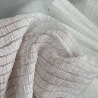 Close-up of Longan Craft’s Plaid Jacquard Lyocell Fabric By The Yard, a multicolor checked, breathable, and lightweight lyocell textile for apparel, showcased with soft folds that highlight its sheer and sustainable texture.