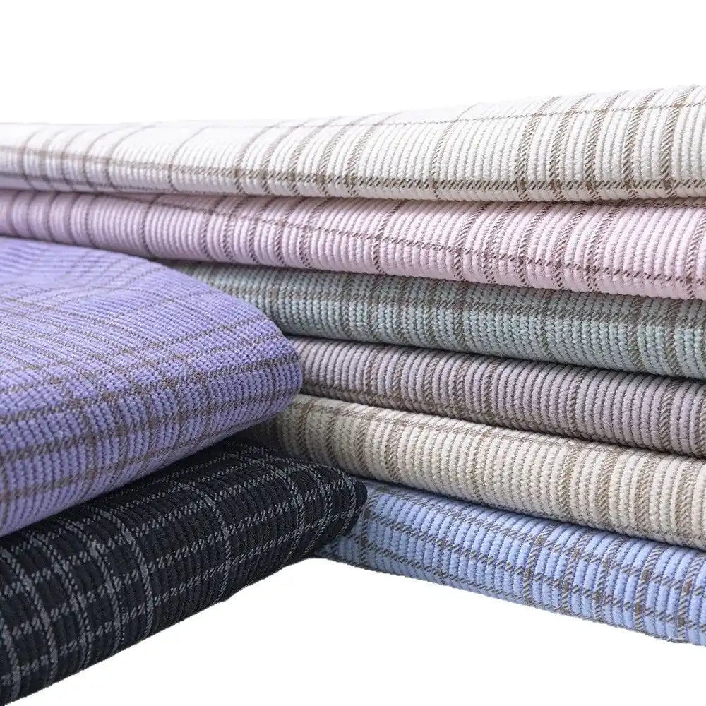 A selection of Longan Craft’s Plaid Print 16 Wale Corduroy Fabric by the yard, featuring colorful fine wale printed corduroy material ideal for pants, neatly arranged against a white background.