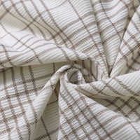 Close-up of Longan Craft’s Plaid Print 16 Wale Corduroy Fabric By The Yard, featuring colorful fine wale corduroy with a brown plaid pattern, gently folded and twisted at the center to showcase its premium texture and weave—ideal for sewing cozy pants or your next creative project.