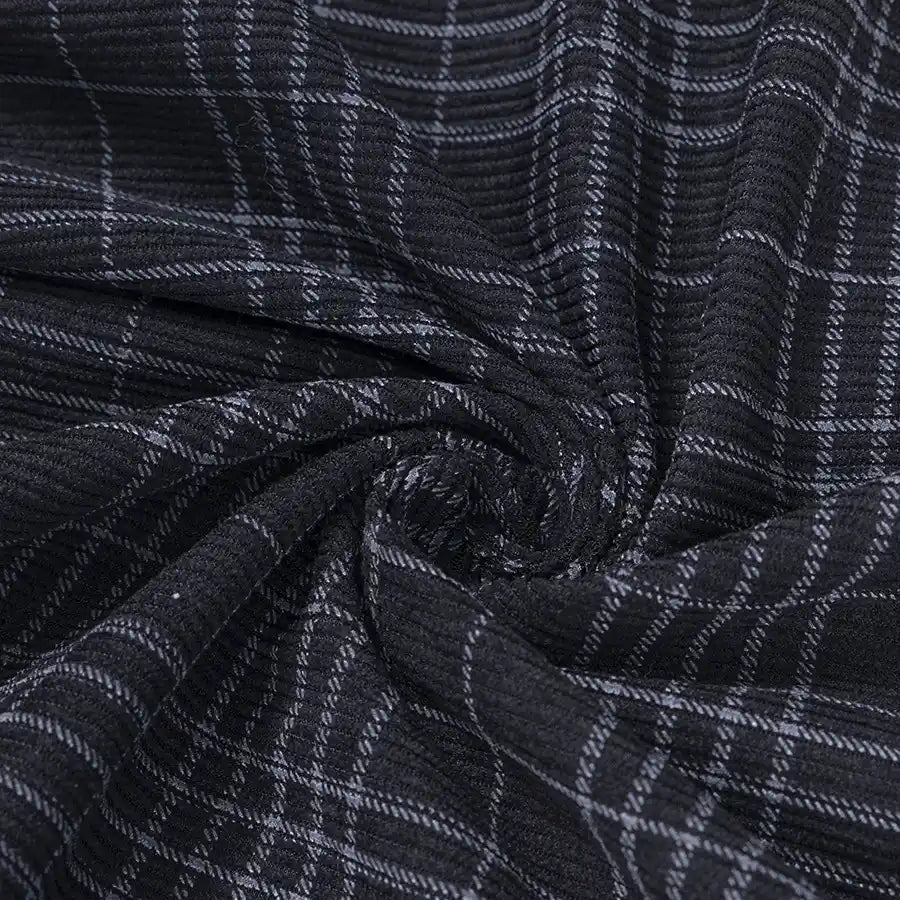 Close-up of Longan Craft’s Plaid Print 16 Wale Corduroy Fabric By The Yard, featuring a white plaid pattern on black fine wale corduroy, gathered and twisted at the center to highlight its premium texture and stretch—perfect for pants and creative sewing projects.