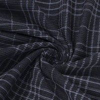 Close-up of Longan Craft’s Plaid Print 16 Wale Corduroy Fabric By The Yard, featuring a white plaid pattern on black fine wale corduroy, gathered and twisted at the center to highlight its premium texture and stretch—perfect for pants and creative sewing projects.