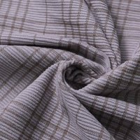 Close-up of the Longan Craft Plaid Print 16 Wale Corduroy Fabric By The Yard, featuring a light gray grid pattern and fine, textured ridges. The colorful, premium corduroy material is shown twisted at the center to showcase its flexibility and detailed surface—making it an ideal choice for pants or any versatile sewing project.