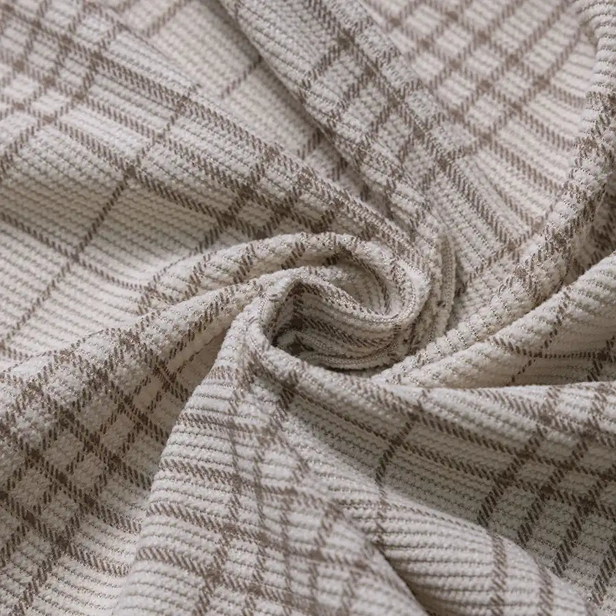 Close-up of Longan Craft’s Plaid Print 16 Wale Corduroy Fabric by the yard, featuring a swirl of soft beige and brown plaid with distinctive intersecting grid lines and a finely textured surface characteristic of this premium, colorful fine wale printed corduroy material—ideal for pants and other sewing projects.