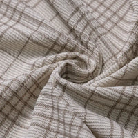 Close-up of Longan Craft’s Plaid Print 16 Wale Corduroy Fabric by the yard, featuring a swirl of soft beige and brown plaid with distinctive intersecting grid lines and a finely textured surface characteristic of this premium, colorful fine wale printed corduroy material—ideal for pants and other sewing projects.