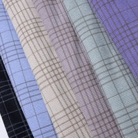 Five pieces of Longan Craft’s Plaid Print 16 Wale Corduroy Fabric by the yard are arranged side by side in black, blue, beige, mint green, and lavender, each displaying a subtle checkered pattern.