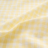 Experience the Plaid Print Double Gauze Fabric By The Yard from Longan Craft—a pure cotton checked printed gauze material in a soft yellow and white plaid pattern. This cozy, breathable fabric features gentle folds and a subtle texture, with pastel colors that create a light, airy look ideal for baby clothing and delicate sewing projects.