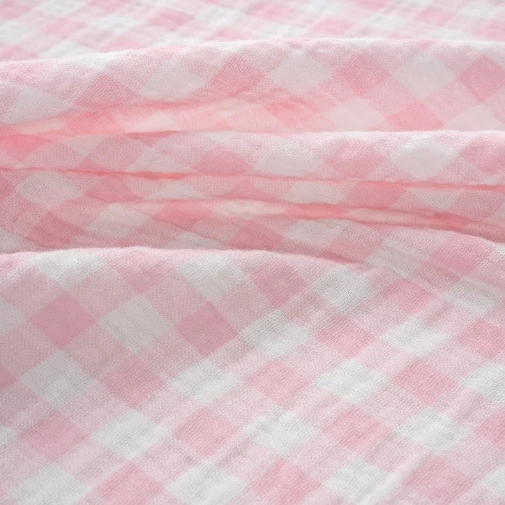 Close-up of Longan Craft’s Plaid Print Double Gauze Fabric by the yard, featuring a pink and white pure cotton checkered print with a soft, textured surface and gentle folds, highlighting its cozy and breathable qualities—perfect for baby clothing.