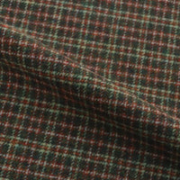 Folded heavy brushed Plaid Wool Fabric By The Yard in a dark green, red, and cream check pattern.