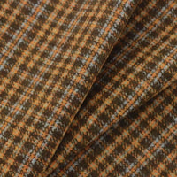 Folded Plaid Wool Fabric By The Yard in a brushed brown, orange, and white pattern.