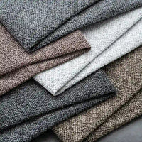 Multiple folded pieces of Longan Craft's Plain Color Boucle Fabric by the yard, made from thick polyester in neutral shades—gray, beige, white, and brown—are neatly stacked for a classic look.