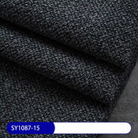 Close-up of folded Longan Craft Plain Color Boucle Fabric By The Yard, featuring a thick pebbled polyester surface—perfect for drapery or upholstery. A white and blue label at the bottom left shows the code SY1087-15.