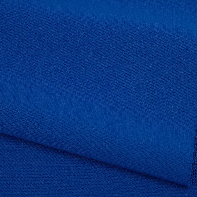 A close-up of Longan Craft’s Plain Color French Terry Fabric By The Yard, a royal blue polyester French terry with a soft, slightly textured surface—perfect for winter clothing.