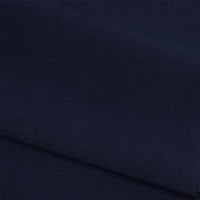 A close-up of Longan Craft's Plain Color French Terry Fabric By The Yard showcases its smooth, dark navy polyester texture with a subtle weave and gentle folds, ideal as a soft, premium material for winter clothing.